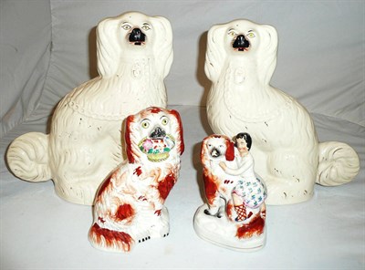 Lot 282 - Pair of Staffordshire dogs, another holding a basket of flowers and a dog with figure (4)