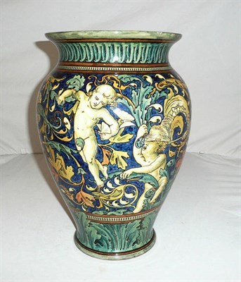 Lot 288 - A Doulton's Bursalem faience vase decorated with putti catching butterflies in maiolica style