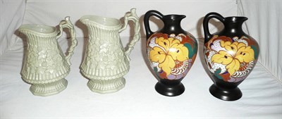 Lot 292 - A pair of Dutch jugs and a pair of relief-moulded jugs