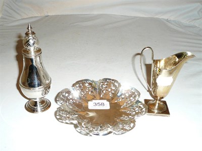 Lot 358 - Pierced silver dish, silver cream jug and a silver caster