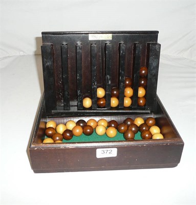 Lot 372 - Remy Martin' game - version of 'Connect 4' with counters as wooden balls in a box