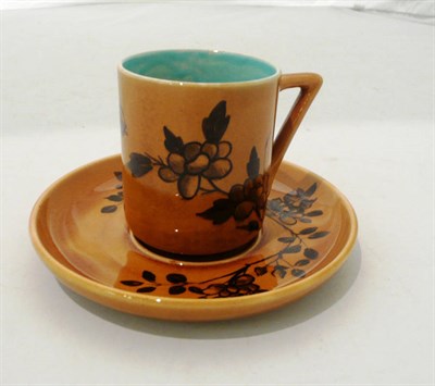 Lot 378 - A Linthorpe pottery cup and saucer, shape No.639, designed by Christopher Dresser, painted with...