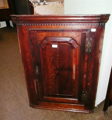 Lot 483 - An 18th century oak hanging corner cupboard