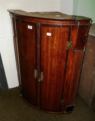 Lot 485 - Oak and mahogany cross-banded bow-fronted hanging corner cupboard