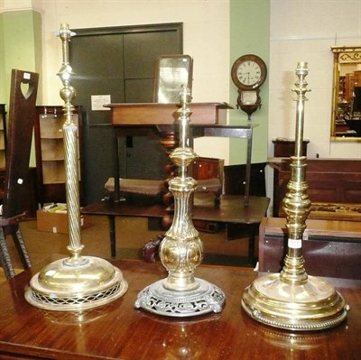 Lot 517 - Three large brass lamps