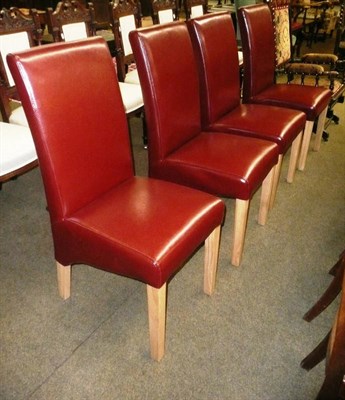 Lot 579 - A set of four contemporary crimson leather upholstered dining chairs