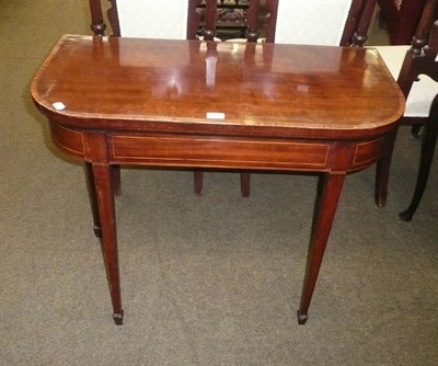 Lot 581 - Mahogany fold-over games table