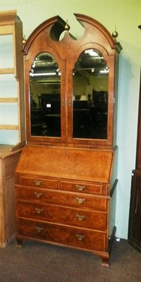 Lot 630 - A reproduction walnut bureau bookcase