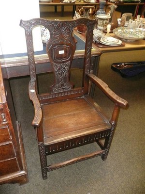 Lot 659 - A carved oak elbow chair