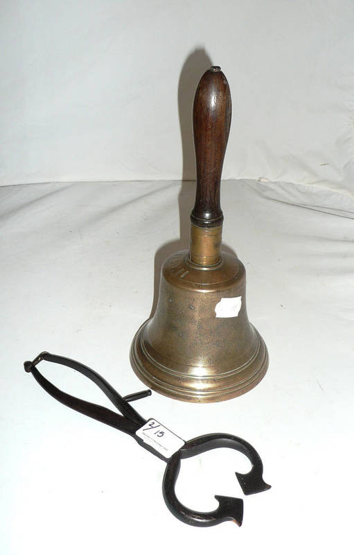 Lot 15 - A bronze handbell and a pair of sugar loaf cutters