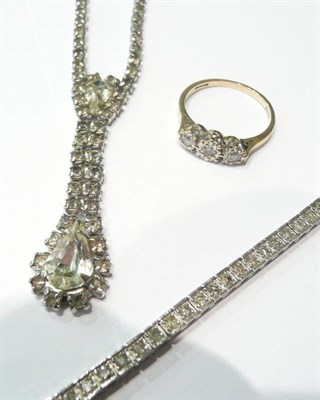 Lot 66 - A diamond line bracelet, a paste necklace and a diamond three stone ring