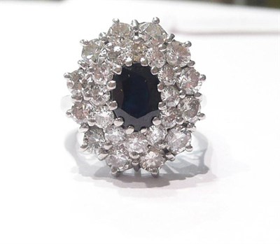 Lot 69 - A sapphire and diamond cluster ring