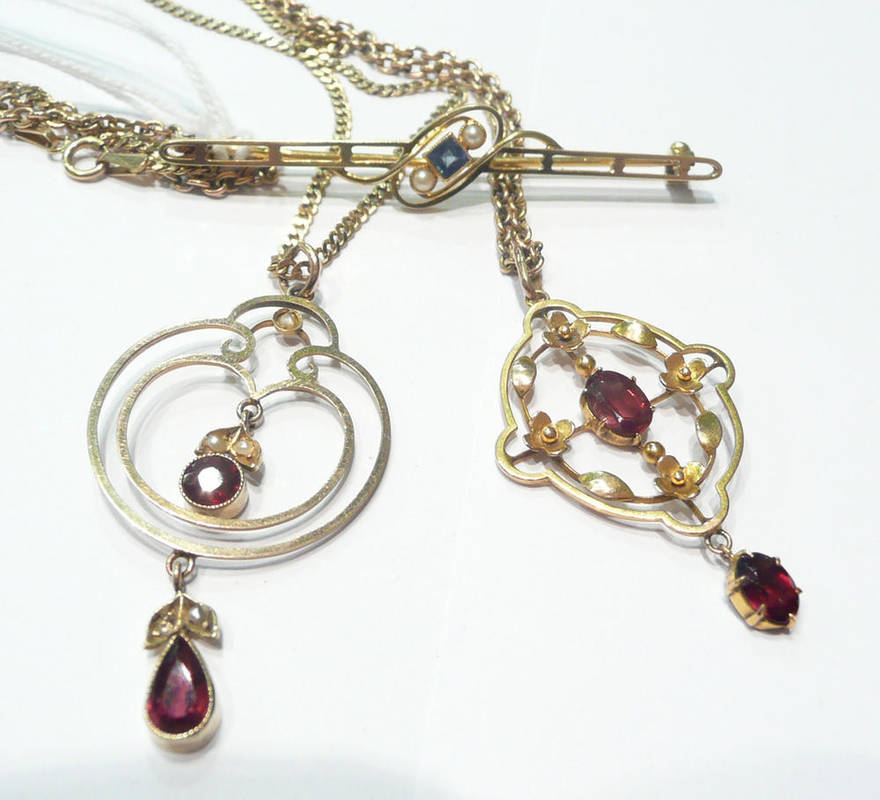 Lot 70 - A garnet set pendant on chain, a garnet and seed pearl set pendant on chain and a bar brooch