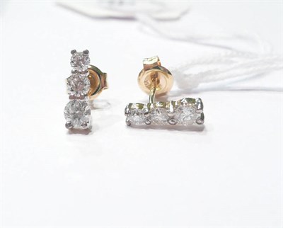 Lot 89 - A pair of 18ct gold three stone graduated diamond drop earrings, 0.60 carat approximately