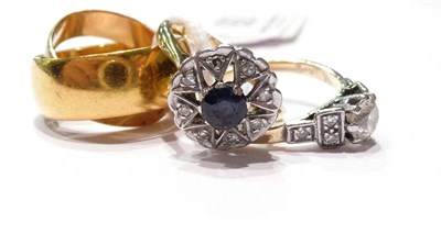Lot 92 - Two 22ct gold band rings, a sapphire and diamond cluster ring and a diamond solitaire ring with...