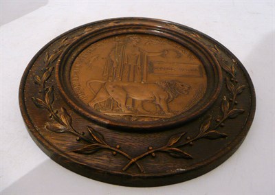 Lot 100 - A bronzed memorial plaque mounted in a carved oak frame
