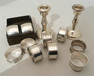 Lot 106 - Box of silver napkin rings and candlesticks