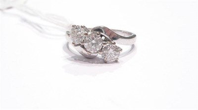 Lot 153 - An 18ct white gold diamond three stone twist ring, 1.20 carat approximately