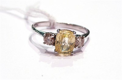 Lot 154 - A 14ct white gold yellow sapphire and diamond ring