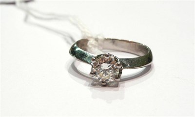 Lot 156 - A platinum diamond solitaire ring, a round brilliant cut diamond in a six claw setting to knife...