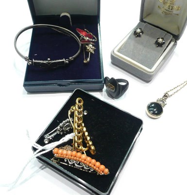 Lot 158 - An agate fob on chain, a silver bangle, two loop brooches, a coral brooch, an enamelled...