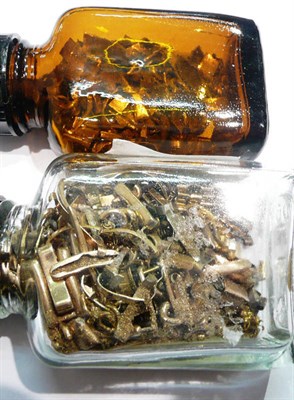 Lot 159 - A stick pin, two bottles containing scrap gold, filings and assorted oddments