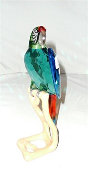 Lot 228 - Coloured glass parrot with white metal beak and claws on a stand