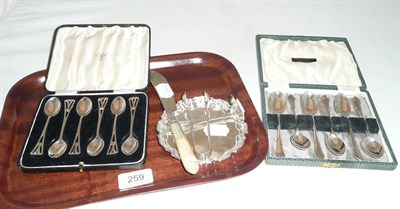 Lot 259 - Two sets of six cased teaspoons, small coaster, tongs, pusher and a butter knife