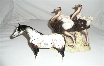 Lot 278 - Beswick Appaloosa stallion and a Goldscheider ostrich figure group