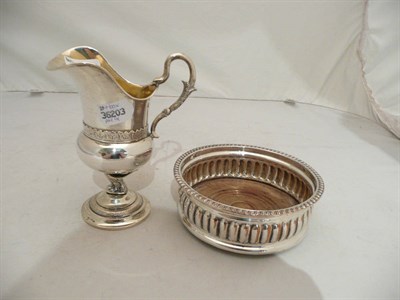 Lot 304 - A box of plated items including candlesticks, wine coaster, helmet shaped jug stamped to the...