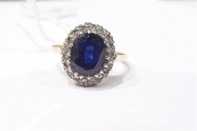 Lot 309 - Ring set with sapphire central stone surrounded by diamonds