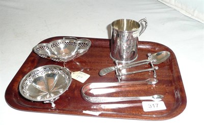 Lot 317 - A small silver mug, pair of silver tongs, pair of silver knife rests and two bonbon dishes, 11.42oz