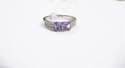 Lot 338 - A 15ct white gold diamond and sapphire half hoop ring