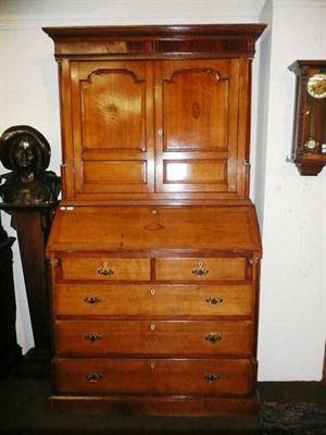 Lot 401 - A Georgian oak bureau bookcase