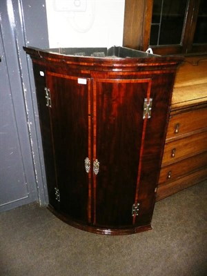 Lot 406 - A George III mahogany and satin wood banded hanging corner cupboard