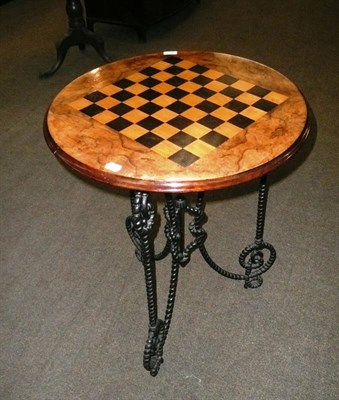 Lot 459 - Cast iron circular walnut chess-top table