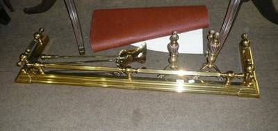 Lot 463 - Extending brass fender and three fire implements