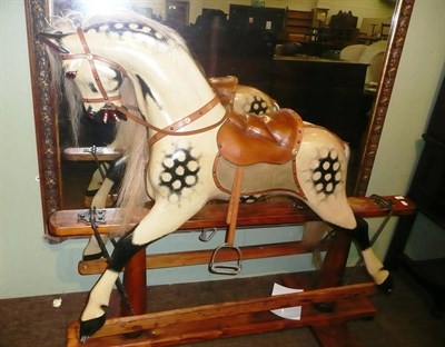 Lot 488 - Dapple grey rocking horse on treadle stand