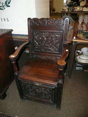 Lot 493 - Carved oak chair purdonium