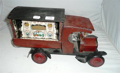 Lot 1169 - A Wood and Tinplate Wagon, with a model of a fairground organ built into the back, electrically...