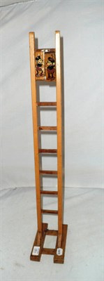 Lot 1181 - A Wooden Mickey and Minnie Mouse Tumbling Toy, comprising a 70cm ladder and two peg shaped tumblers