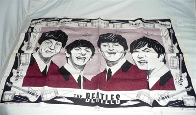 Lot 1311 - An Irish Linen Tea Towel Printed with Portraits of The Beatles, with a black & white musical...