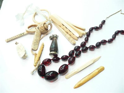 Lot 56 - A collection of bone and ivory pieces, pre-1946 and an amber necklace