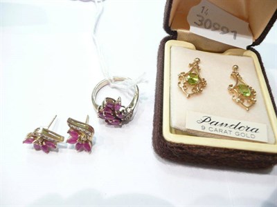 Lot 79 - A ruby and diamond ring with matching earrings and a pair of peridot earrings