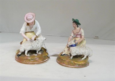 Lot 88 - A pair of 19th century Staffordshire figures, man shearing a sheep and woman securing a ram