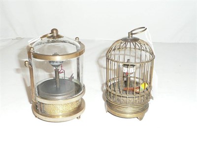 Lot 89 - A fish automaton 'Mystery Clock' in brass and glazed case and another of a bird in a cage (2)