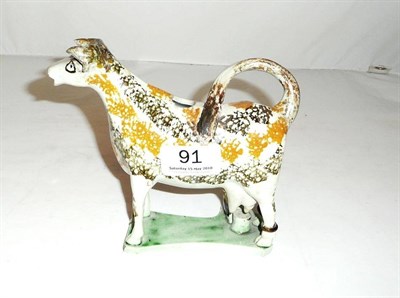 Lot 91 - A 19th century Prattware pottery cow creamer, restored