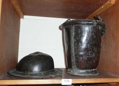 Lot 106 - Leather bucket and porter's helmet