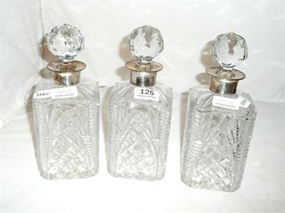 Lot 125 - Three cut glass decanters and stoppers with silver mounts