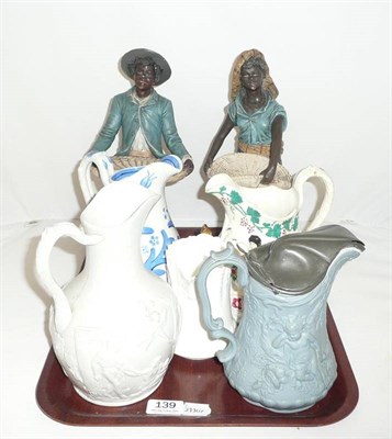 Lot 139 - Pair of pottery figures, two 19th century relief-moulded jugs and three other jugs